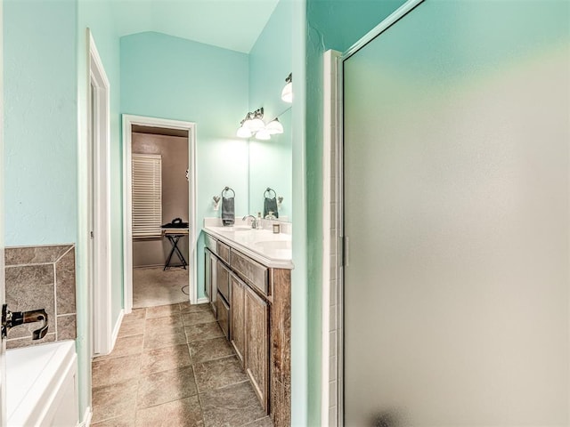 516 SW 161st St, Oklahoma City, OK 73170 - bathroom featuring a stall shower, vanity, a bath, and vaulted ceiling