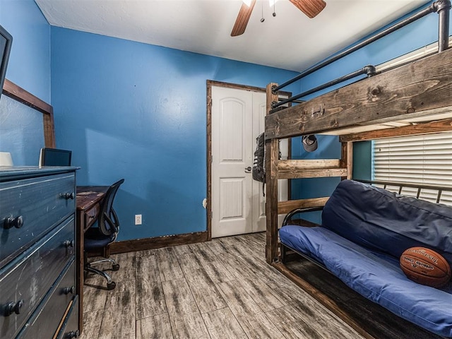 516 SW 161st St, Oklahoma City, OK 73170 - bedroom featuring wood finished floors, a ceiling fan, and an office area