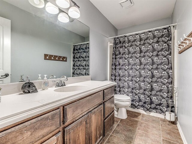 516 SW 161st St, Oklahoma City, OK 73170 - full bathroom featuring vanity, stone finish flooring, and curtained shower