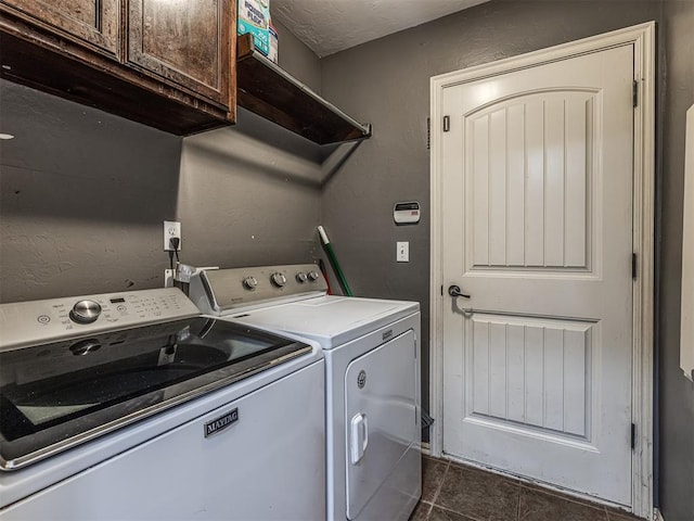 516 SW 161st St, Oklahoma City, OK 73170 - laundry room with cabinet space, washing machine and clothes dryer, and dark tile patterned flooring