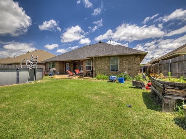 516 SW 161st St, Oklahoma City, OK 73170 - back of house with a patio, a shingled roof, and brick siding
