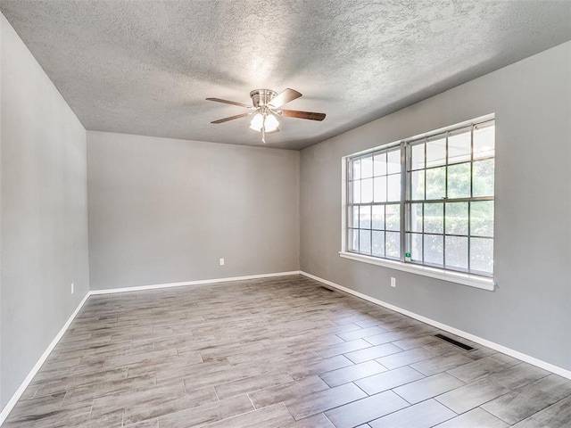 1917 Barryton Rd, Oklahoma City, OK 73120 - spare room with ceiling fan, a textured ceiling, and wood finished floors