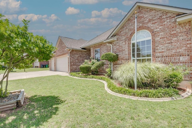 4621 Deer Ridge Blvd, Yukon, OK 73099 - view of front of house featuring brick siding, concrete driveway, a front yard, an attached garage, and a shingled roof