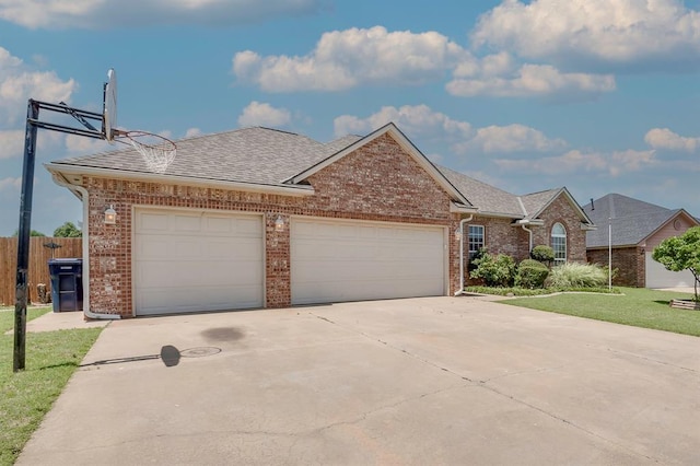 4621 Deer Ridge Blvd, Yukon, OK 73099 - view of front of house with brick siding, a garage, driveway, and roof with shingles