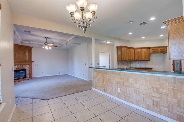 4621 Deer Ridge Blvd, Yukon, OK 73099 - kitchen featuring light carpet, light tile patterned floors, brown cabinetry, ceiling fan, and recessed lighting