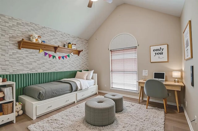 4621 Deer Ridge Blvd, Yukon, OK 73099 - bedroom with an accent wall, wood finished floors, lofted ceiling, wallpapered walls, and ceiling fan