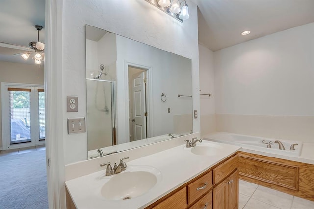 4621 Deer Ridge Blvd, Yukon, OK 73099 - bathroom featuring double vanity, a bath, a stall shower, a ceiling fan, and tile patterned flooring