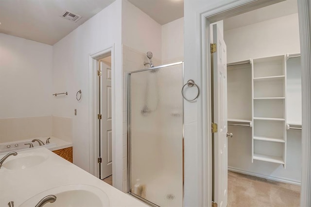 4621 Deer Ridge Blvd, Yukon, OK 73099 - bathroom featuring a stall shower, a spacious closet, and double vanity