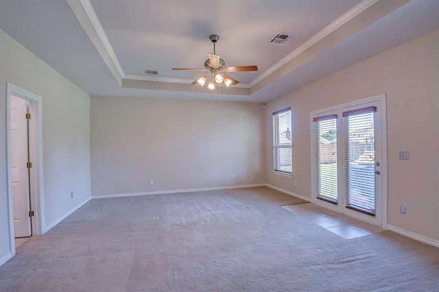 4621 Deer Ridge Blvd, Yukon, OK 73099 - carpeted spare room with a tray ceiling, a ceiling fan, and crown molding