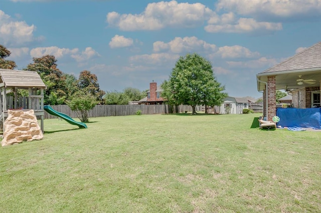 4621 Deer Ridge Blvd, Yukon, OK 73099 - fenced backyard with a playground and ceiling fan