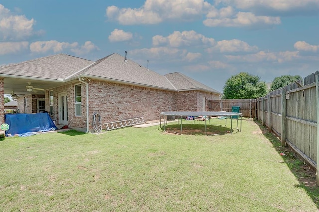 4621 Deer Ridge Blvd, Yukon, OK 73099 - fenced backyard featuring a trampoline and ceiling fan
