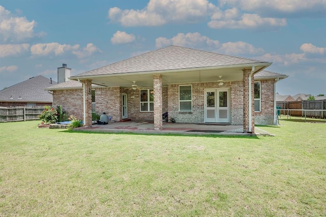 4621 Deer Ridge Blvd, Yukon, OK 73099 - back of property with ceiling fan, a fenced backyard, and brick siding