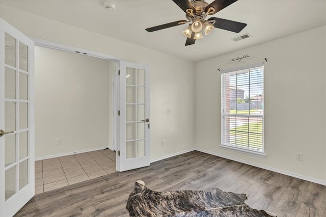 11321 NW 103rd St, Yukon, OK 73099 - spare room with french doors, wood finished floors, a smoke detector, and a ceiling fan