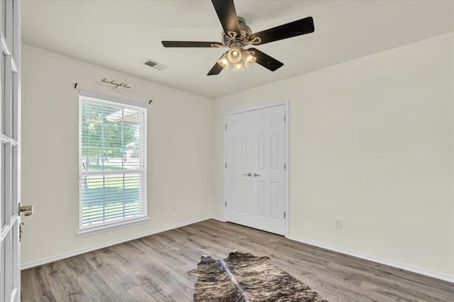 11321 NW 103rd St, Yukon, OK 73099 - unfurnished bedroom with wood finished floors, a ceiling fan, and a closet