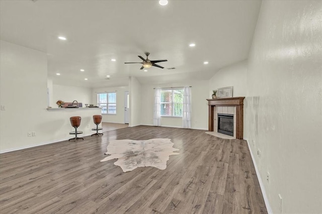 11321 NW 103rd St, Yukon, OK 73099 - unfurnished living room with ceiling fan, wood finished floors, a tiled fireplace, and recessed lighting