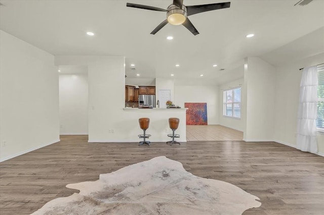 11321 NW 103rd St, Yukon, OK 73099 - living room featuring light wood-type flooring, a ceiling fan, and recessed lighting