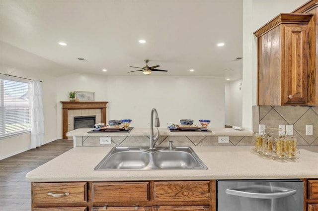 11321 NW 103rd St, Yukon, OK 73099 - kitchen featuring stainless steel dishwasher, brown cabinetry, ceiling fan, wood finished floors, and recessed lighting