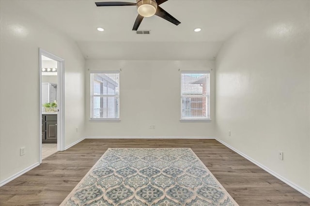 11321 NW 103rd St, Yukon, OK 73099 - spare room with a ceiling fan, wood finished floors, vaulted ceiling, and recessed lighting