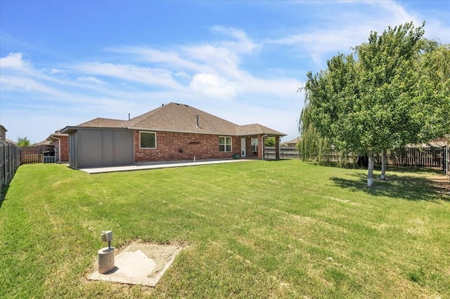 11321 NW 103rd St, Yukon, OK 73099 - back of house featuring brick siding, a fenced backyard, and a patio