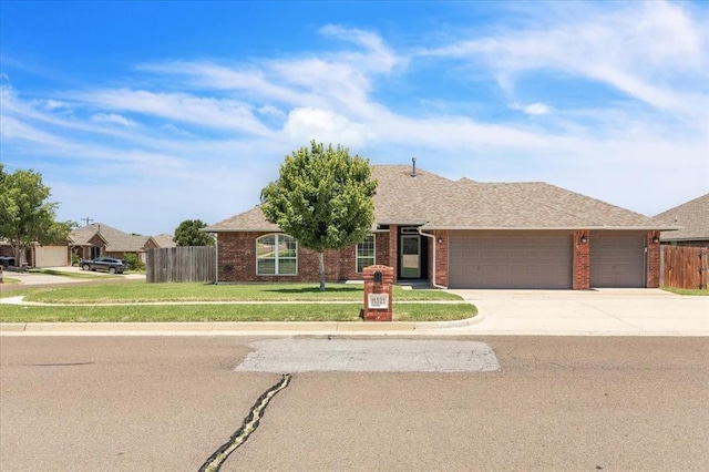11321 NW 103rd St, Yukon, OK 73099 - ranch-style home with an attached garage, driveway, brick siding, and roof with shingles