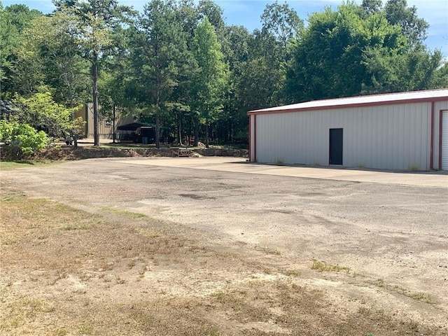 50 Spearfish Rd, Broken Bow, OK 74728 - view of yard featuring a garage and an outdoor structure