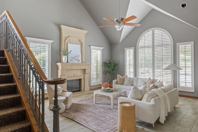 4719 W Two Lakes Ave, Norman, OK 73072 - living room with a fireplace, ceiling fan, high vaulted ceiling, and stairs