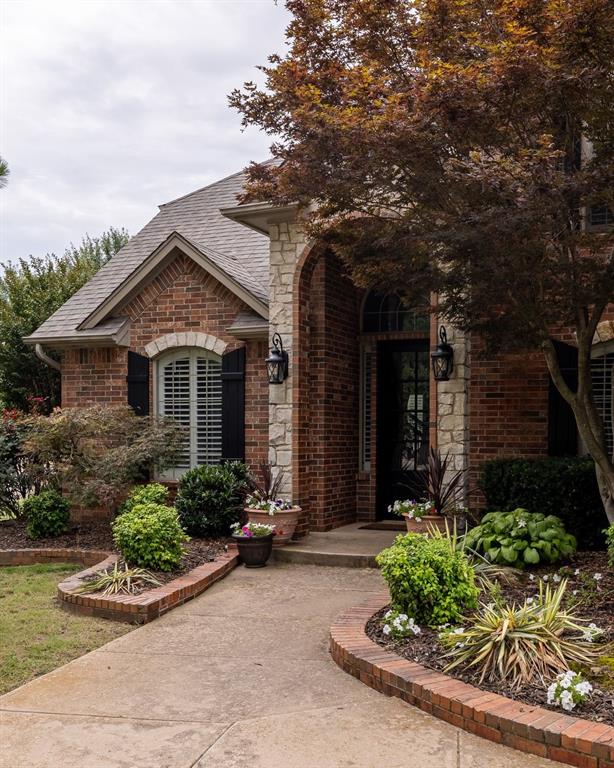 4719 W Two Lakes Ave, Norman, OK 73072 - doorway to property with brick siding and a shingled roof