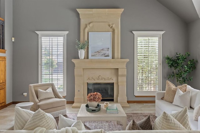 4719 W Two Lakes Ave, Norman, OK 73072 - living room featuring a fireplace, plenty of natural light, and vaulted ceiling