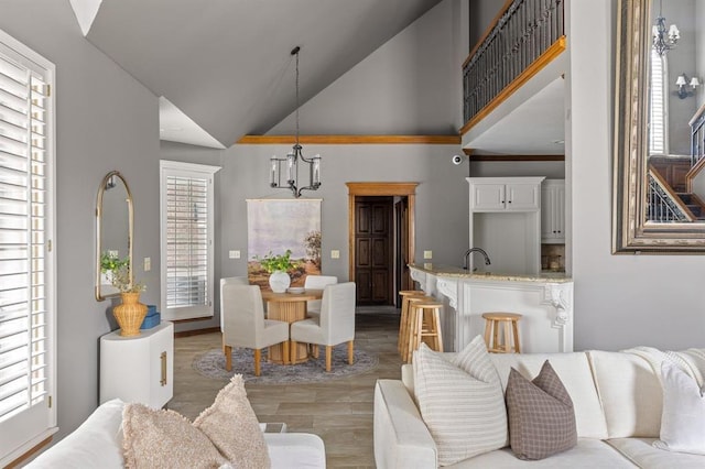 4719 W Two Lakes Ave, Norman, OK 73072 - living area featuring high vaulted ceiling, a chandelier, and light wood-type flooring