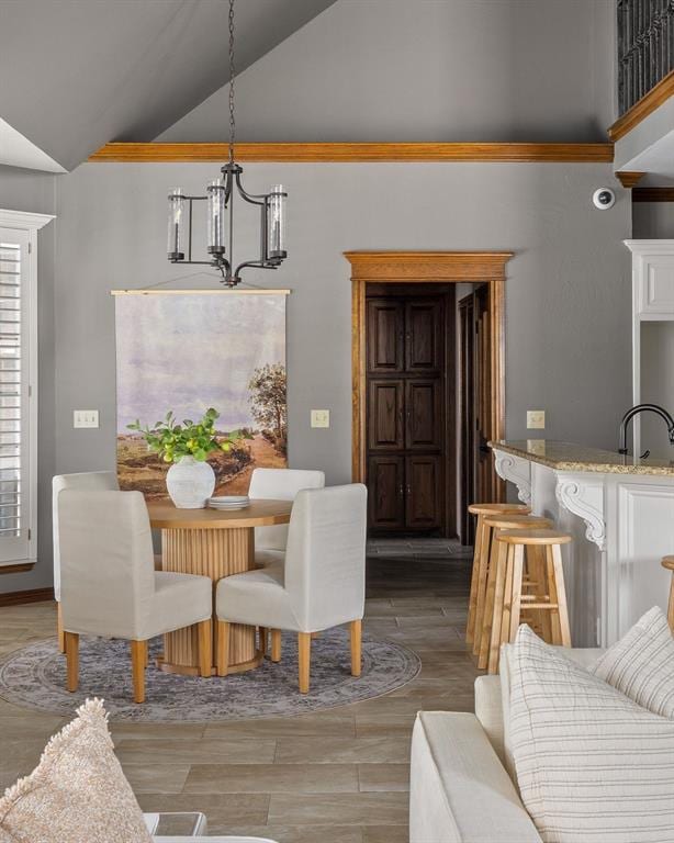 4719 W Two Lakes Ave, Norman, OK 73072 - dining space with a chandelier, light wood-style flooring, and high vaulted ceiling
