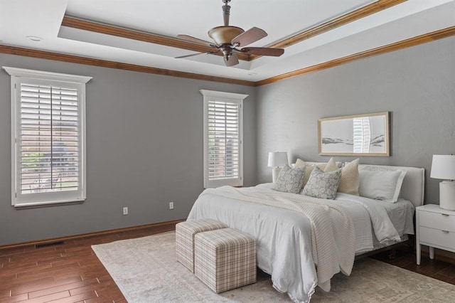 4719 W Two Lakes Ave, Norman, OK 73072 - bedroom featuring a raised ceiling, multiple windows, hardwood / wood-style flooring, and crown molding
