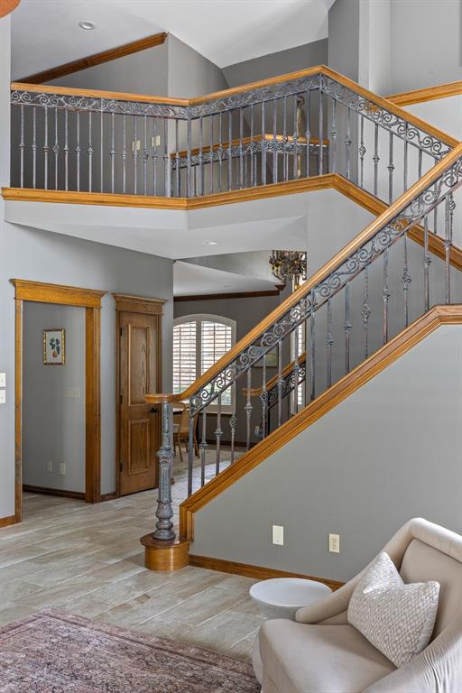 4719 W Two Lakes Ave, Norman, OK 73072 - stairway with a high ceiling and wood finished floors