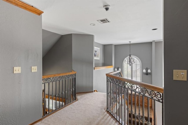 4719 W Two Lakes Ave, Norman, OK 73072 - hallway with an upstairs landing, carpet, and a chandelier