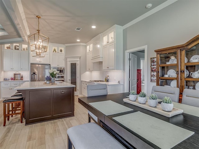 10101 NW 137th St, Yukon, OK 73099 - kitchen with stainless steel appliances, white cabinetry, a chandelier, a center island, and recessed lighting