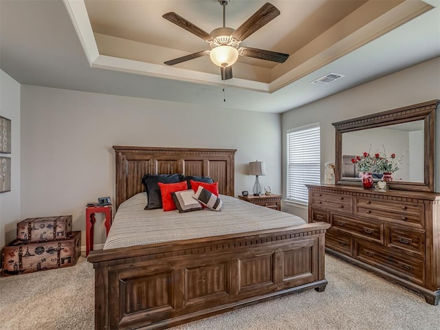 10101 NW 137th St, Yukon, OK 73099 - bedroom with light carpet, a raised ceiling, and a ceiling fan