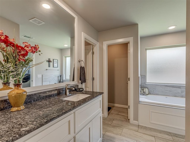 10101 NW 137th St, Yukon, OK 73099 - bathroom featuring vanity and a bath