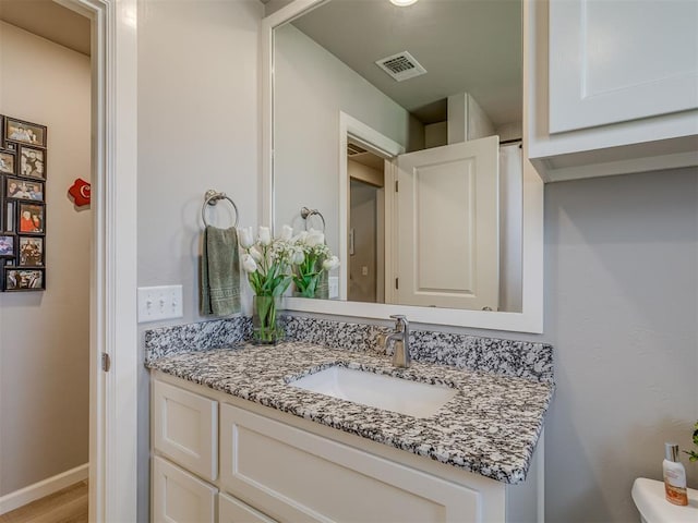 10101 NW 137th St, Yukon, OK 73099 - bathroom featuring vanity and wood finished floors