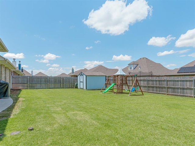 10101 NW 137th St, Yukon, OK 73099 - fenced backyard with a storage shed and a playground