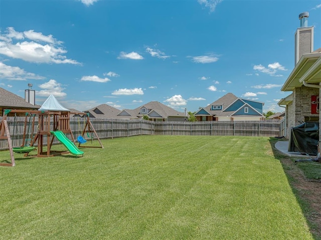 10101 NW 137th St, Yukon, OK 73099 - fenced backyard featuring a playground and a residential view