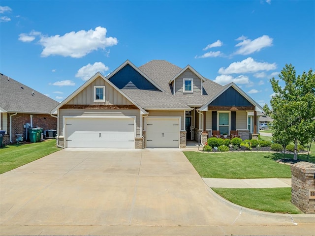 10101 NW 137th St, Yukon, OK 73099 - craftsman inspired home featuring an attached garage, a front yard, board and batten siding, a porch, and driveway