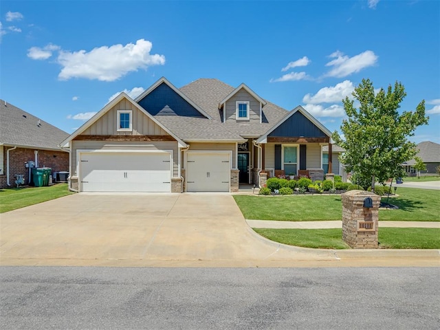 10101 NW 137th St, Yukon, OK 73099 - craftsman-style home with a front yard, an attached garage, board and batten siding, driveway, and a shingled roof