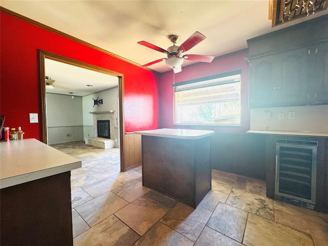 302 NE 60th St, Oklahoma City, OK 73105 - kitchen with beverage cooler, ceiling fan, light countertops, a fireplace, and light stone finish floors