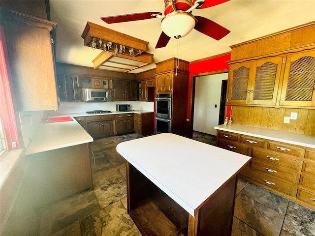 302 NE 60th St, Oklahoma City, OK 73105 - kitchen with stainless steel appliances, dark stone finish flooring, and light countertops