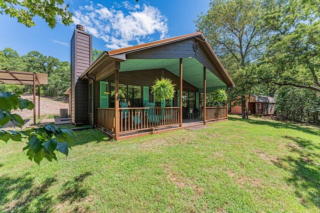22797 N Henney Rd, Luther, OK 73054 - rear view of property featuring a chimney, a storage shed, and a yard