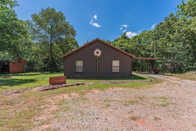 22797 N Henney Rd, Luther, OK 73054 - view of home's exterior with a lawn and an outdoor structure