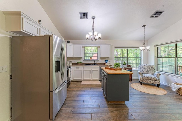 22797 N Henney Rd, Luther, OK 73054 - kitchen with stainless steel refrigerator with ice dispenser, butcher block countertops, lofted ceiling, a chandelier, and dark wood finished floors