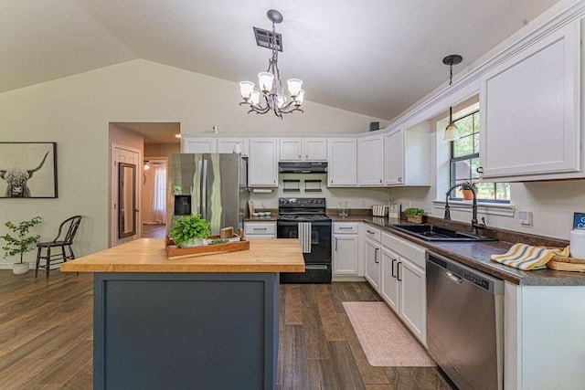 22797 N Henney Rd, Luther, OK 73054 - kitchen featuring appliances with stainless steel finishes, butcher block countertops, vaulted ceiling, under cabinet range hood, and white cabinets