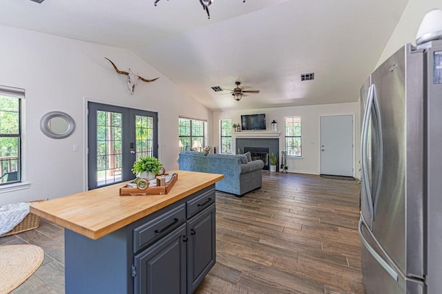 22797 N Henney Rd, Luther, OK 73054 - kitchen featuring freestanding refrigerator, wood counters, lofted ceiling, a ceiling fan, and dark wood-type flooring
