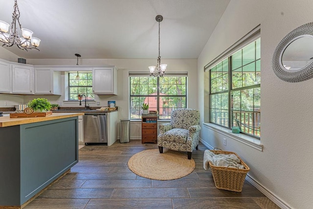 22797 N Henney Rd, Luther, OK 73054 - kitchen featuring stainless steel dishwasher, a chandelier, butcher block counters, white cabinetry, and dark wood finished floors