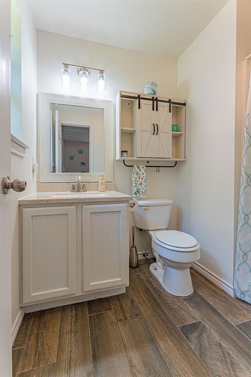 22797 N Henney Rd, Luther, OK 73054 - full bathroom featuring wood finished floors and vanity